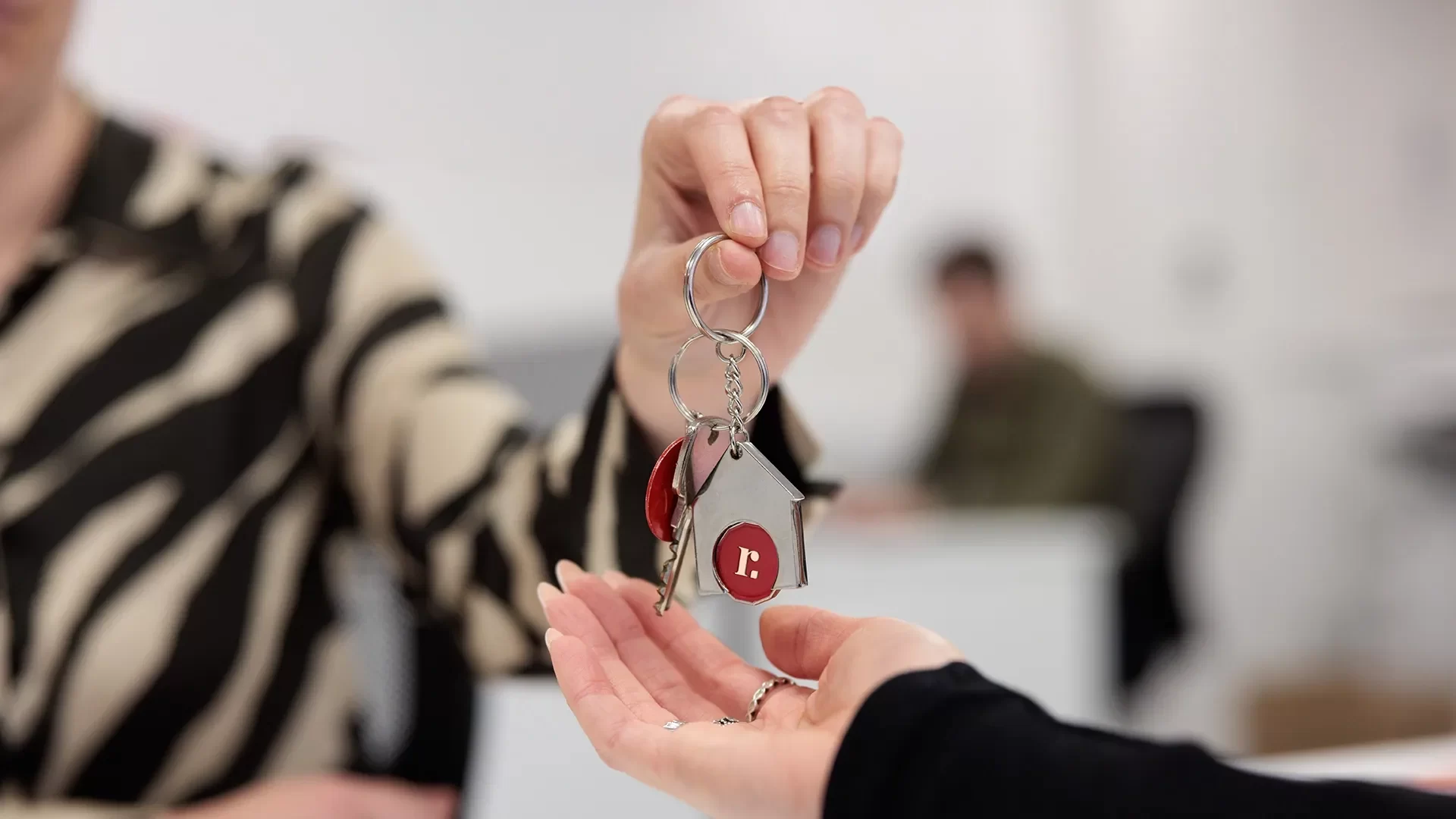 An estate agent from Redwing hands over the keys to a new property owner.
