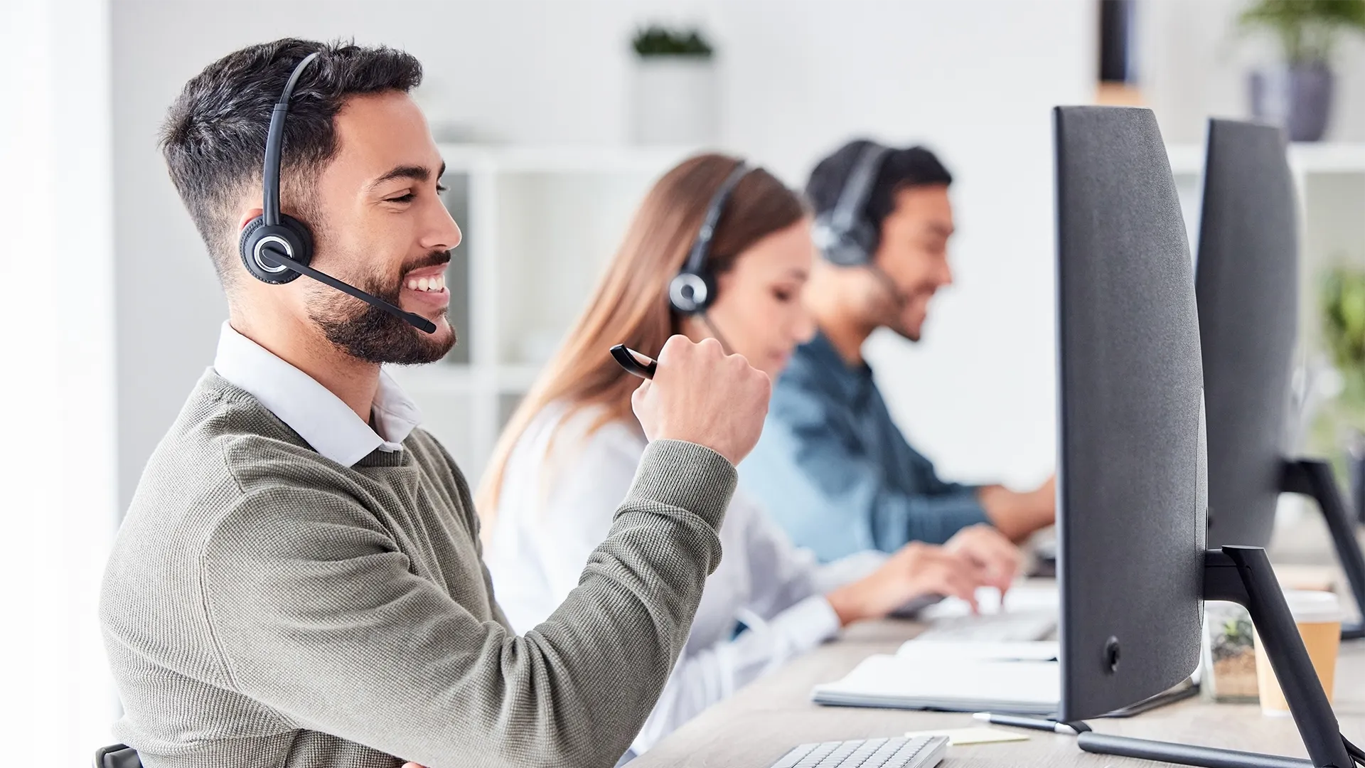 Guy on the phone to a customer in the office