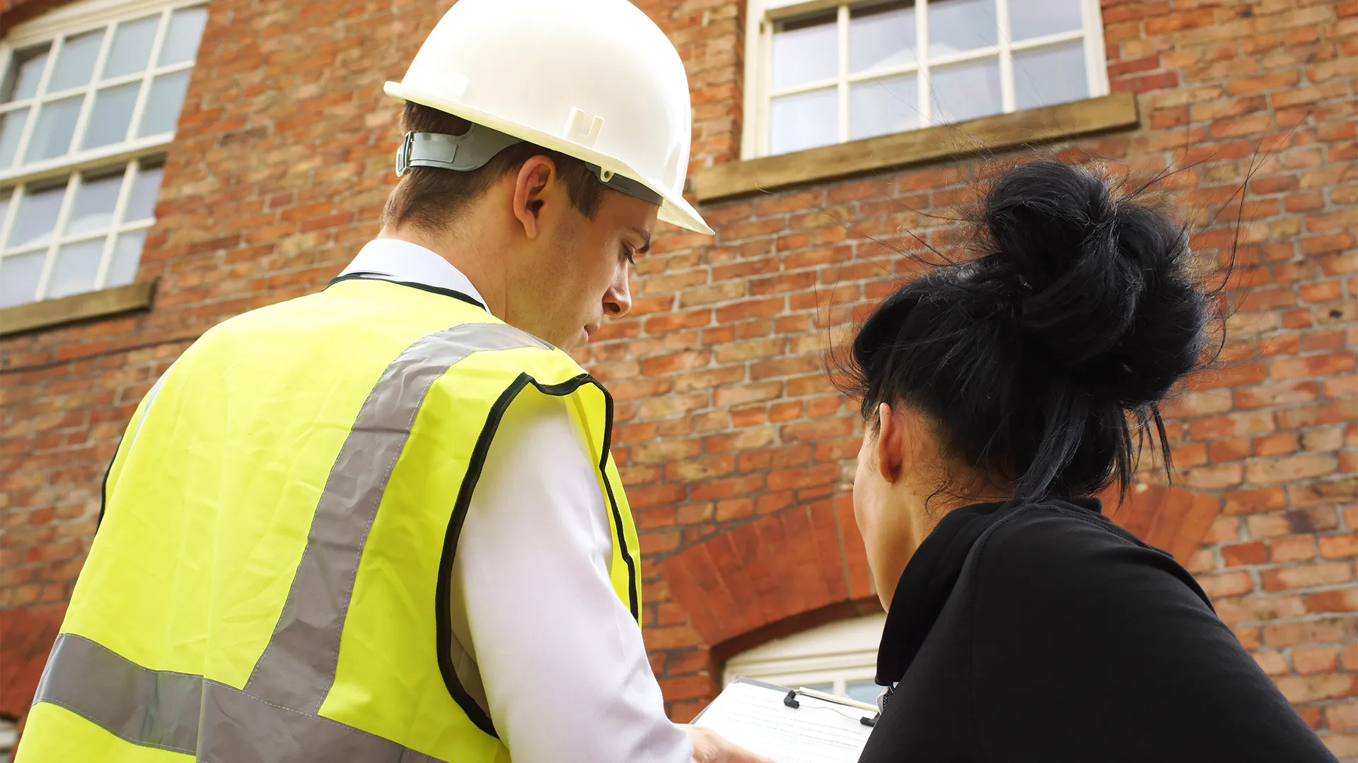 Construction worker talking to a client