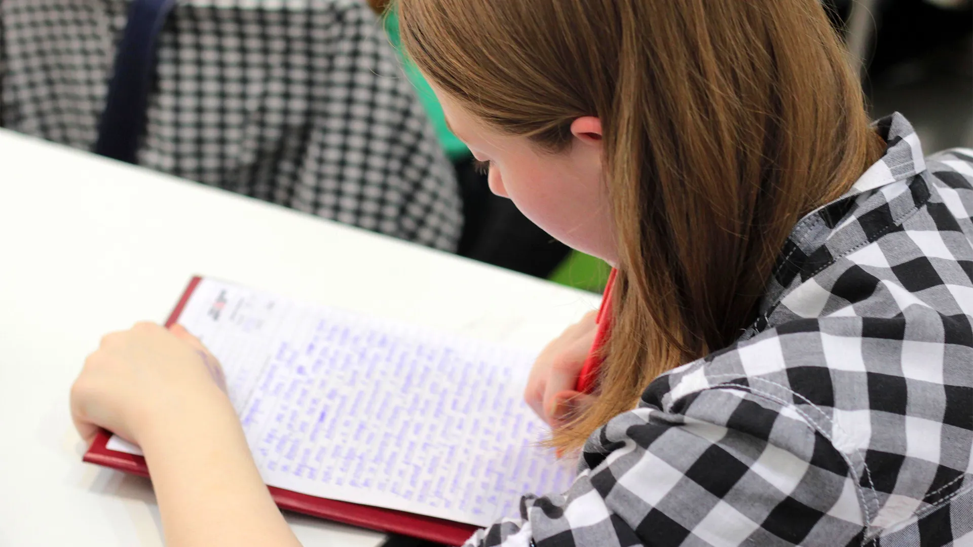 Girl writing at The Learning Foundry