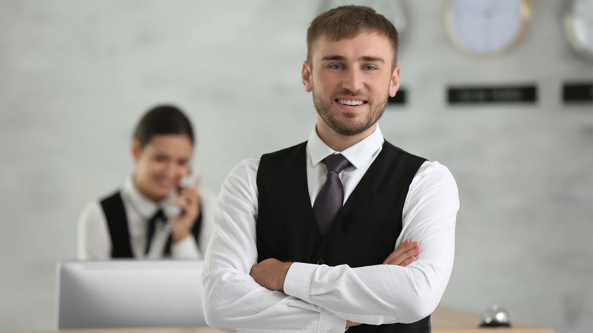 hospitality worker standing at the front desk