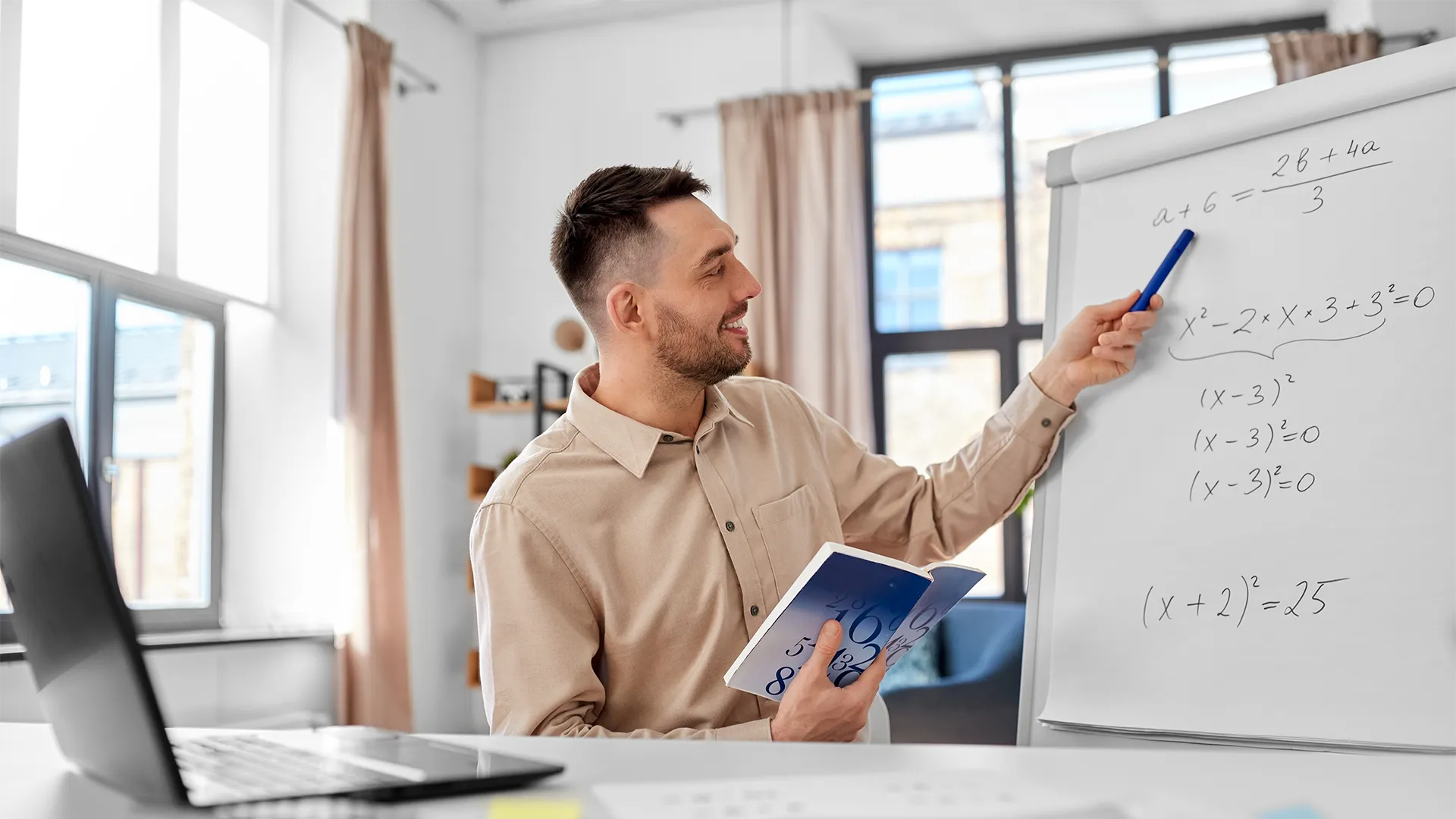 Guy looking at his working out on a whiteboard